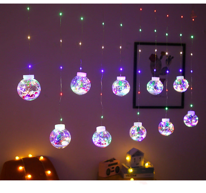 Lichtgordijn met kerstballen en kerstfiguren