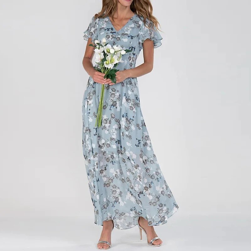 
                  
                    Elvianne – Lange Zomerjurk met Levendige Bloemenprint - SkinzLine
                  
                