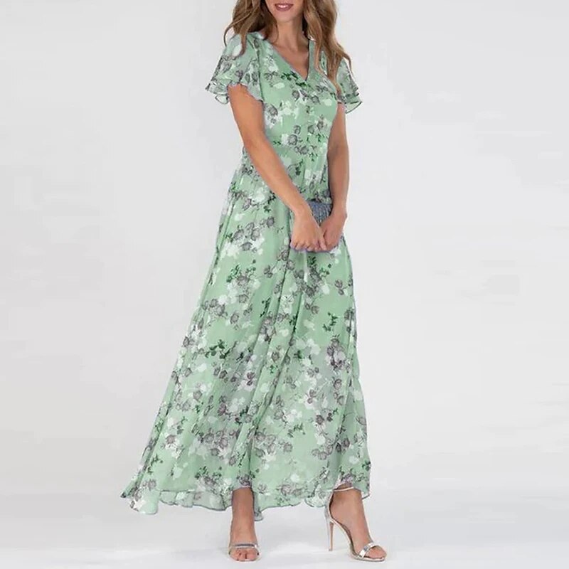
                  
                    Elvianne – Lange Zomerjurk met Levendige Bloemenprint - SkinzLine
                  
                