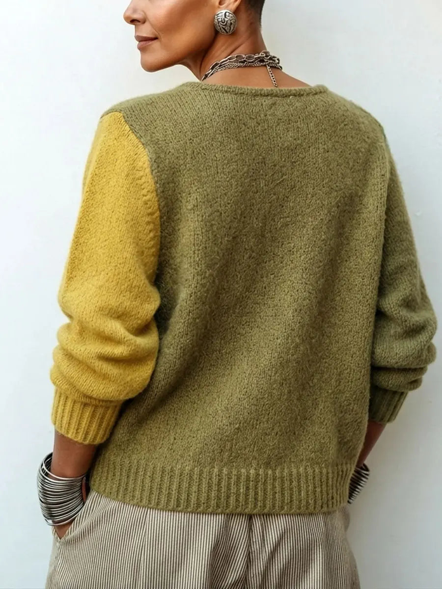 Gebreide damestrui met asymmetrische knopen in colour-block-look
