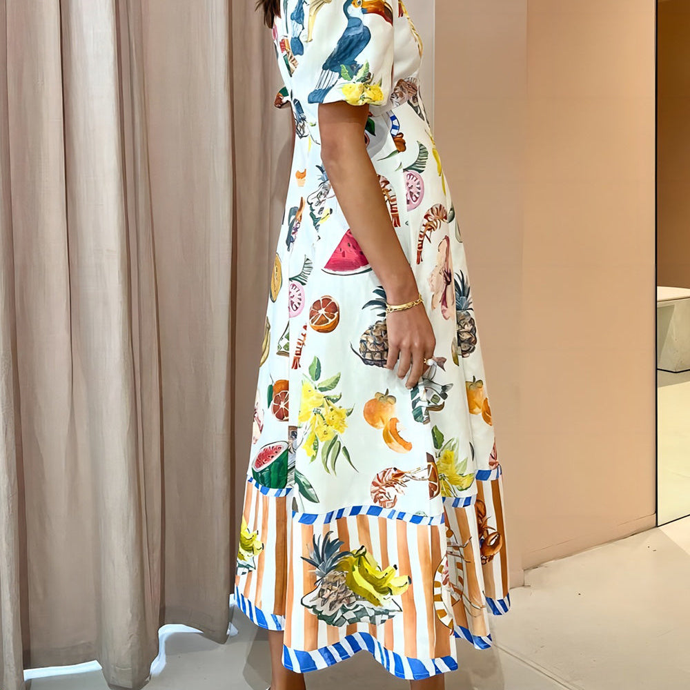 
                  
                    Tropica - Maxi Jurk met Fruit Print en Pofmouwen - SkinzLine
                  
                
